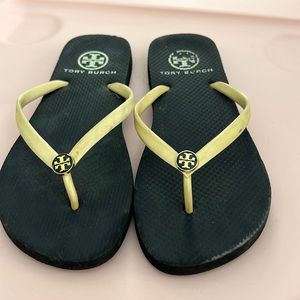 Tory Burch cream flip flop with gold medallion logo.